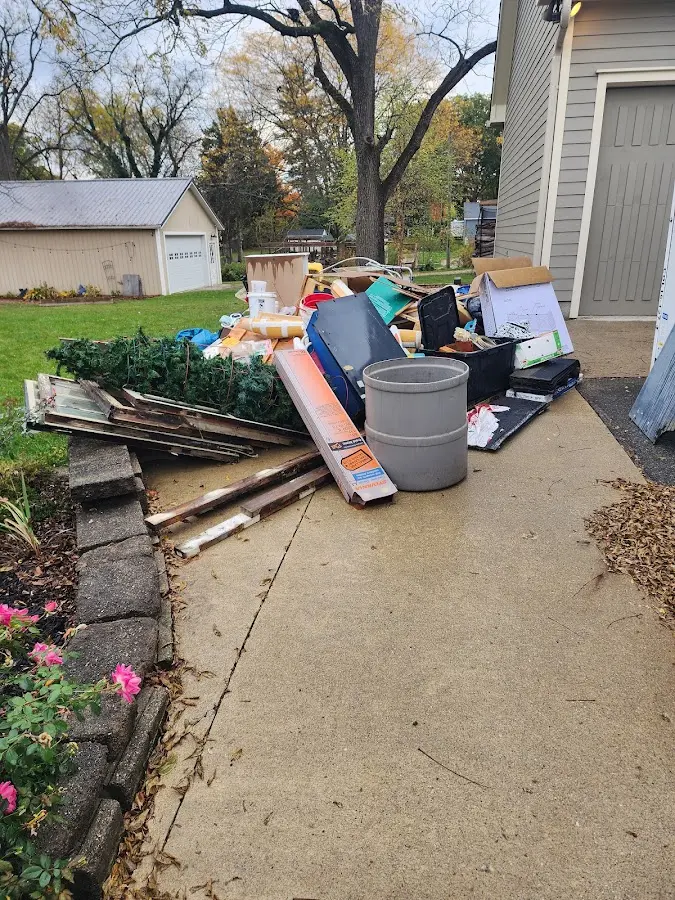 Dumpster being loaded with debris for Estate Cleanout Dumpster Rental in Haverford